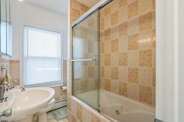 a bathroom with a bathtub and a sink