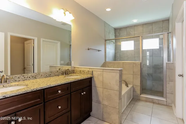 a bathroom with a granite countertop sink mirror and double