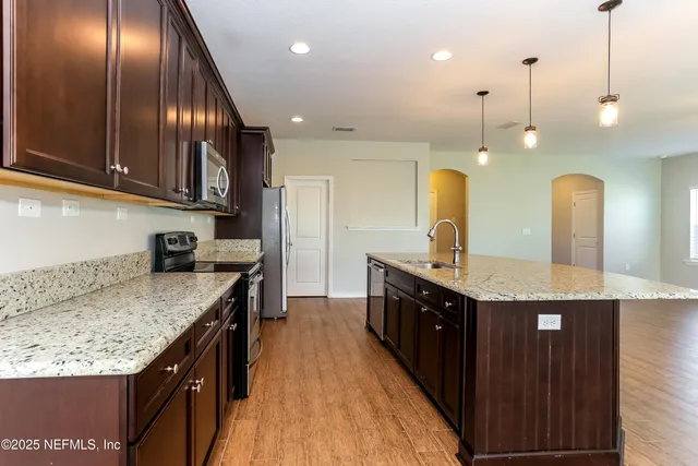 a kitchen with stainless steel appliances granite countertop plenty wooden cabinets