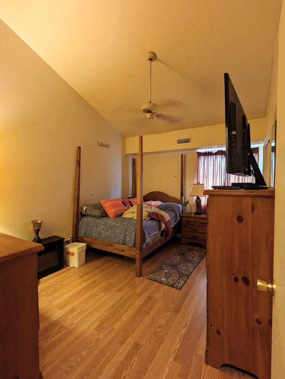 1112 Blue Ridge Drive, Unit 9 Harrisonburg, VA 22802 - Photo 12 of 13 a bedroom with a bed and wooden floor