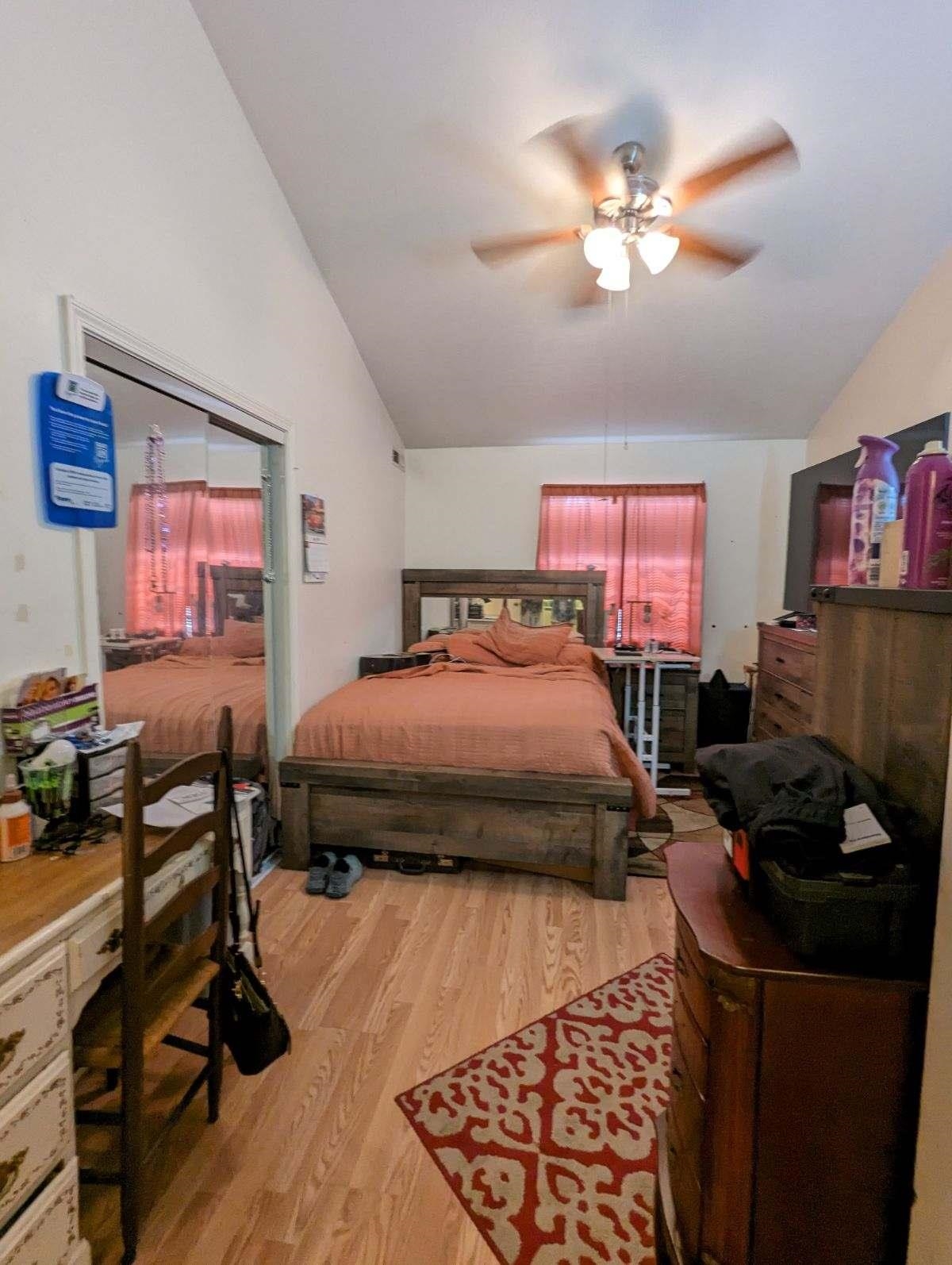 1112 Blue Ridge Drive, Unit 9 Harrisonburg, VA 22802 - Photo 8 of 13 a bedroom with a bed and a chandelier