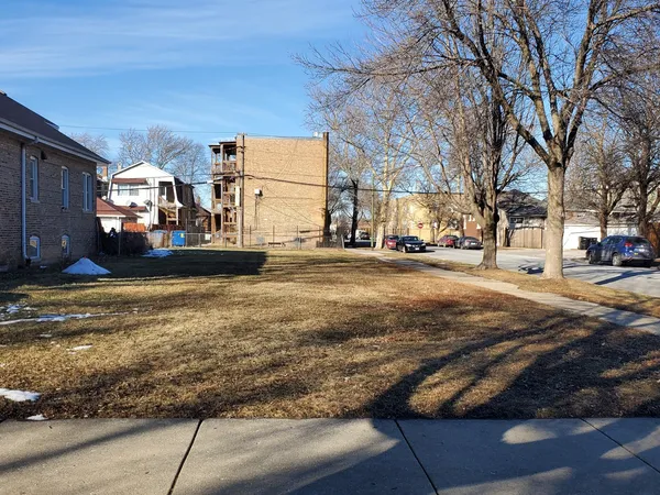 a view of a city street lined with buildings and cars