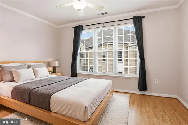 a bedroom with a large bed and a large window