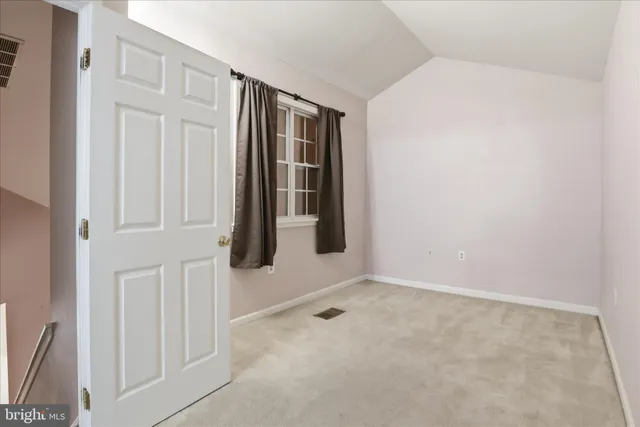 a bedroom with a bed and walk in closet