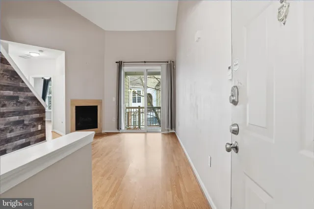 a view of a hallway with wooden floor and a fireplace