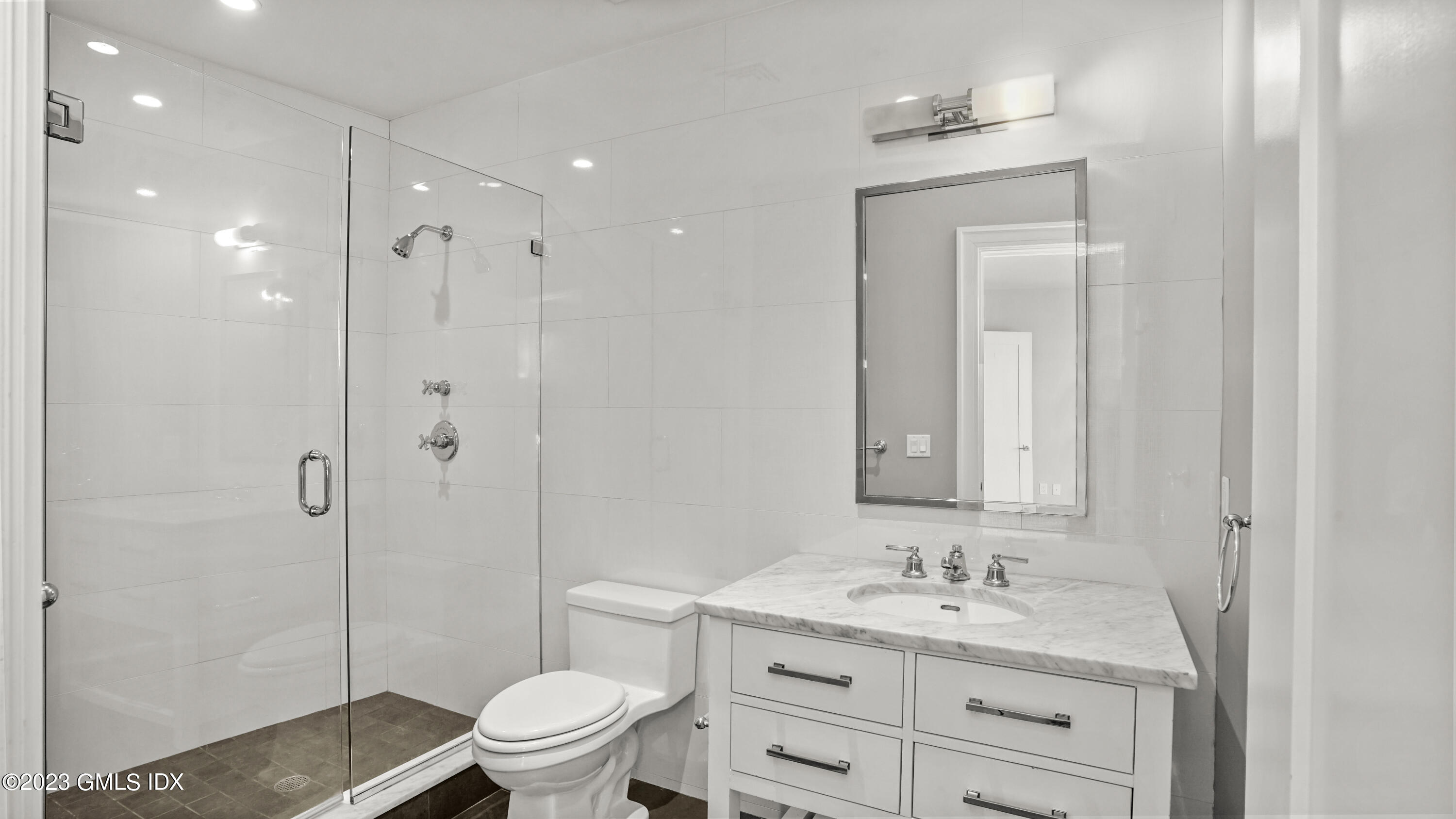 409 Greenwich Avenue, Unit A Greenwich, CT 06830 - Photo 12 of 17 a bathroom with a granite countertop sink toilet a mirror and shower