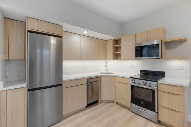 a kitchen with a sink stove and refrigerator