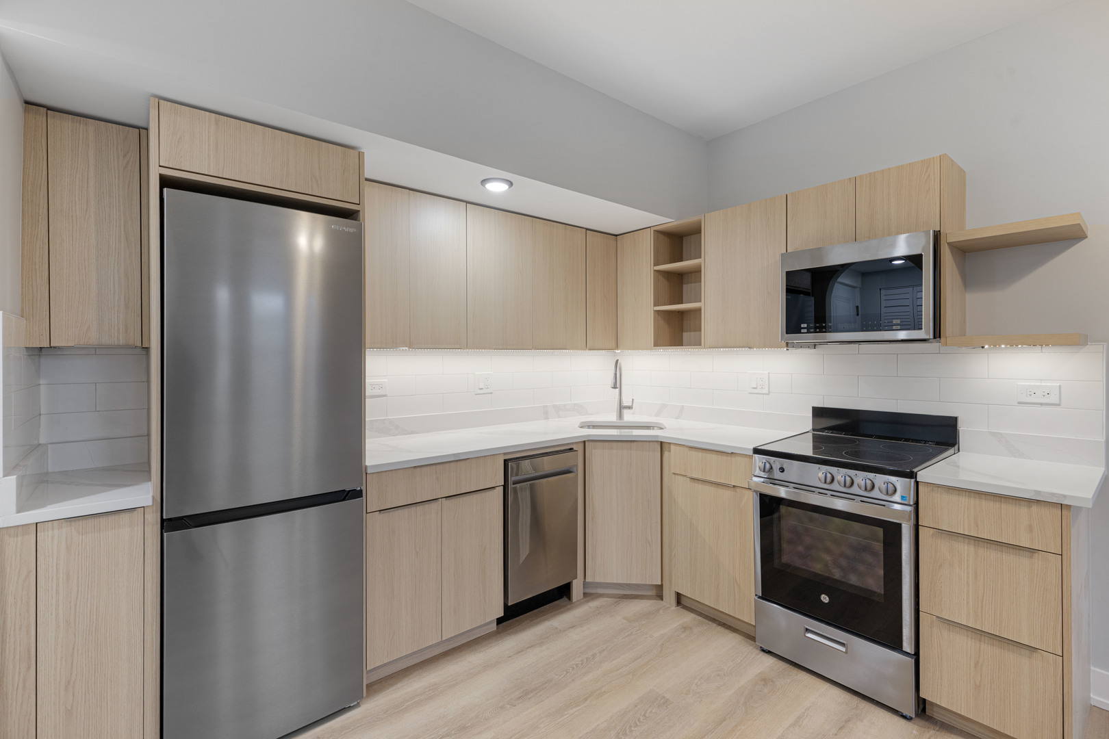 1634 West Howard Street, Unit 202 Chicago, IL 60626 - Photo 3 of 7 a kitchen with a sink stove and refrigerator
