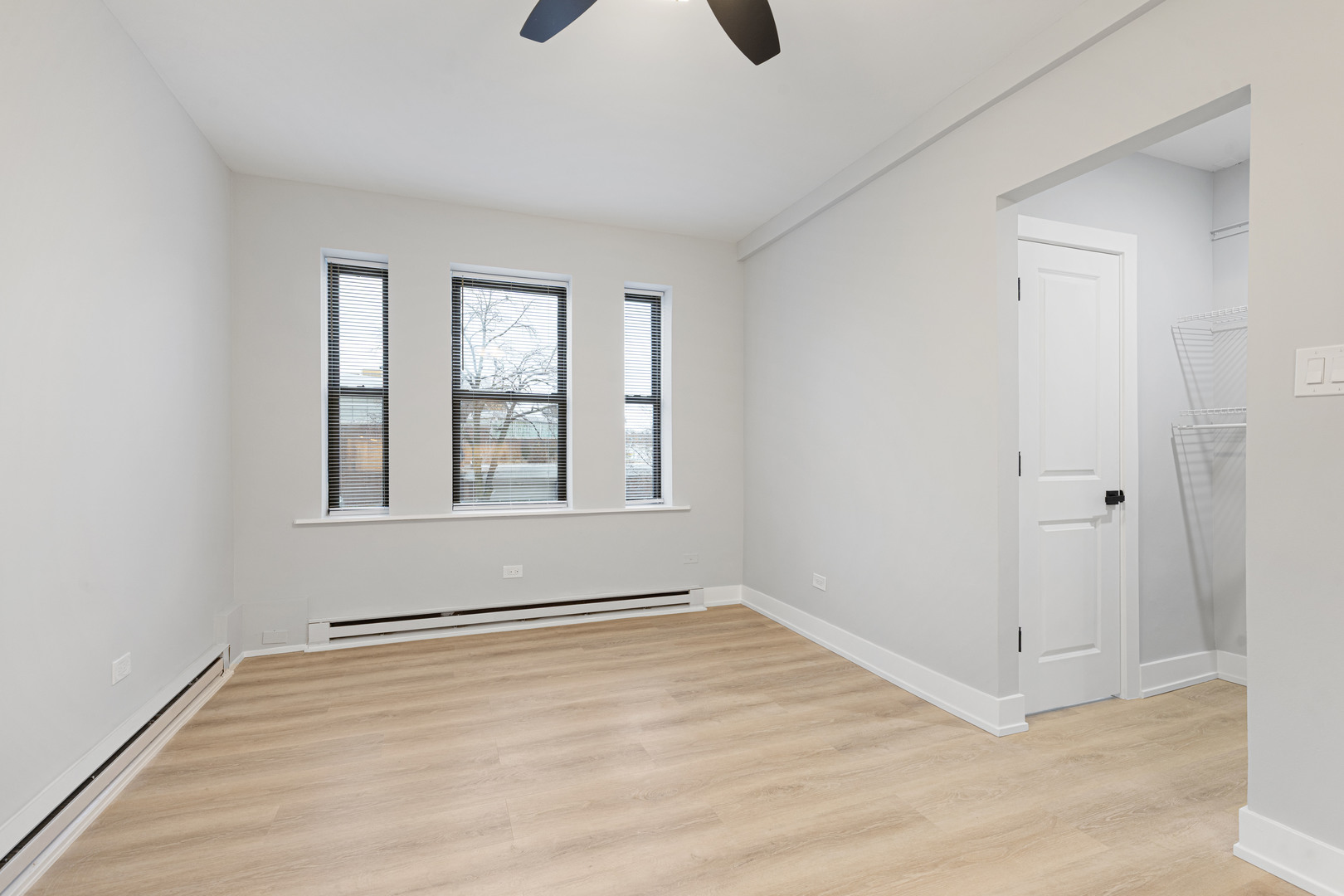 1634 West Howard Street, Unit 202 Chicago, IL 60626 - Photo 4 of 7 wooden floor in an empty room with a window