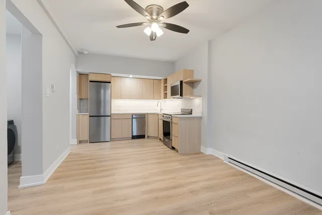 a view of kitchen with wooden floor electronic appliances and window