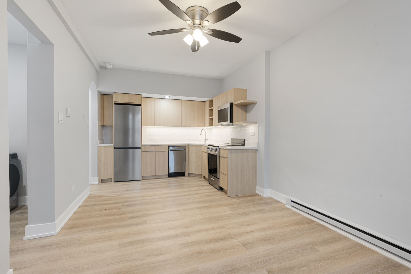 1634 West Howard Street, Unit 202 Chicago, IL 60626 - Photo 5 of 7 a view of kitchen with wooden floor electronic appliances and window