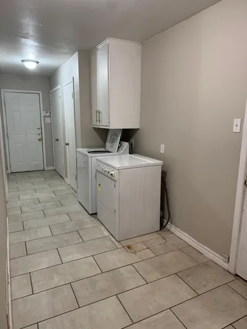 a view of a kitchen with a sink washer and dryer