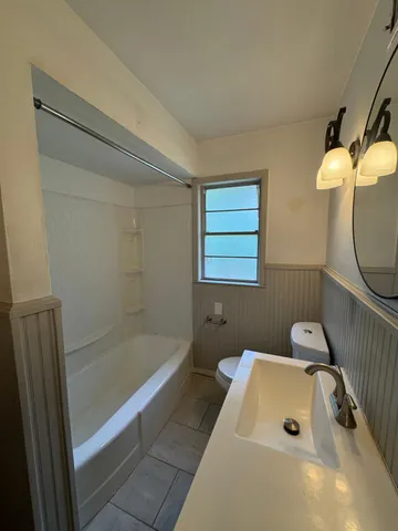 a bathroom with a sink a toilet and a bathtub