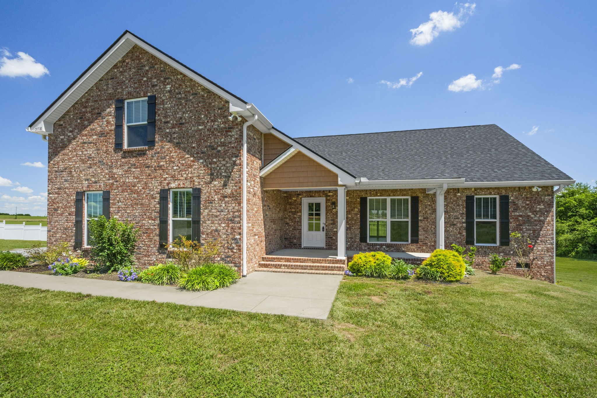 a front view of a house with an outdoor space and porch