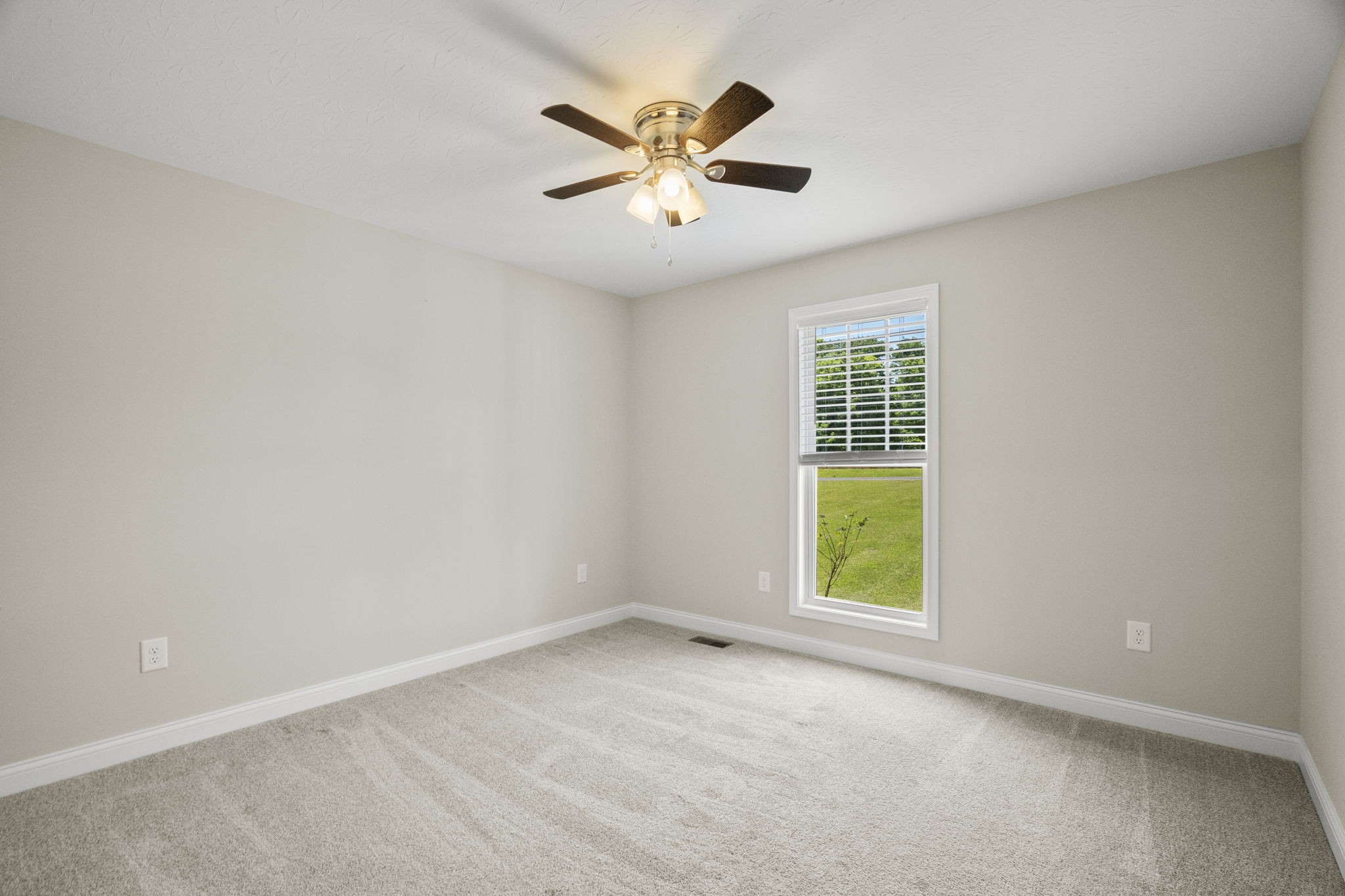5718 Hoods Branch Road Springfield, TN 37172 - Photo 16 of 47 an empty room with windows and ceiling fan