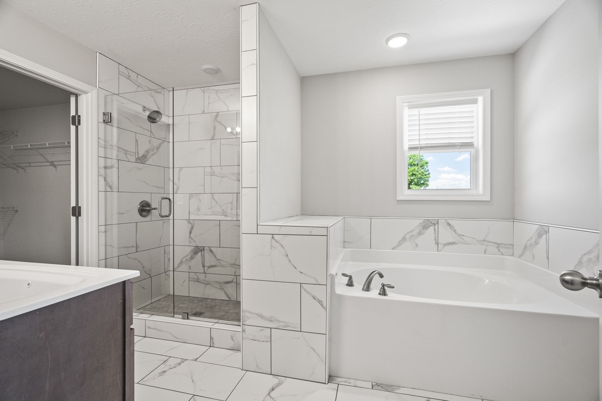 5718 Hoods Branch Road Springfield, TN 37172 - Photo 26 of 47 a white bath tub sitting next to a white sink and a shower