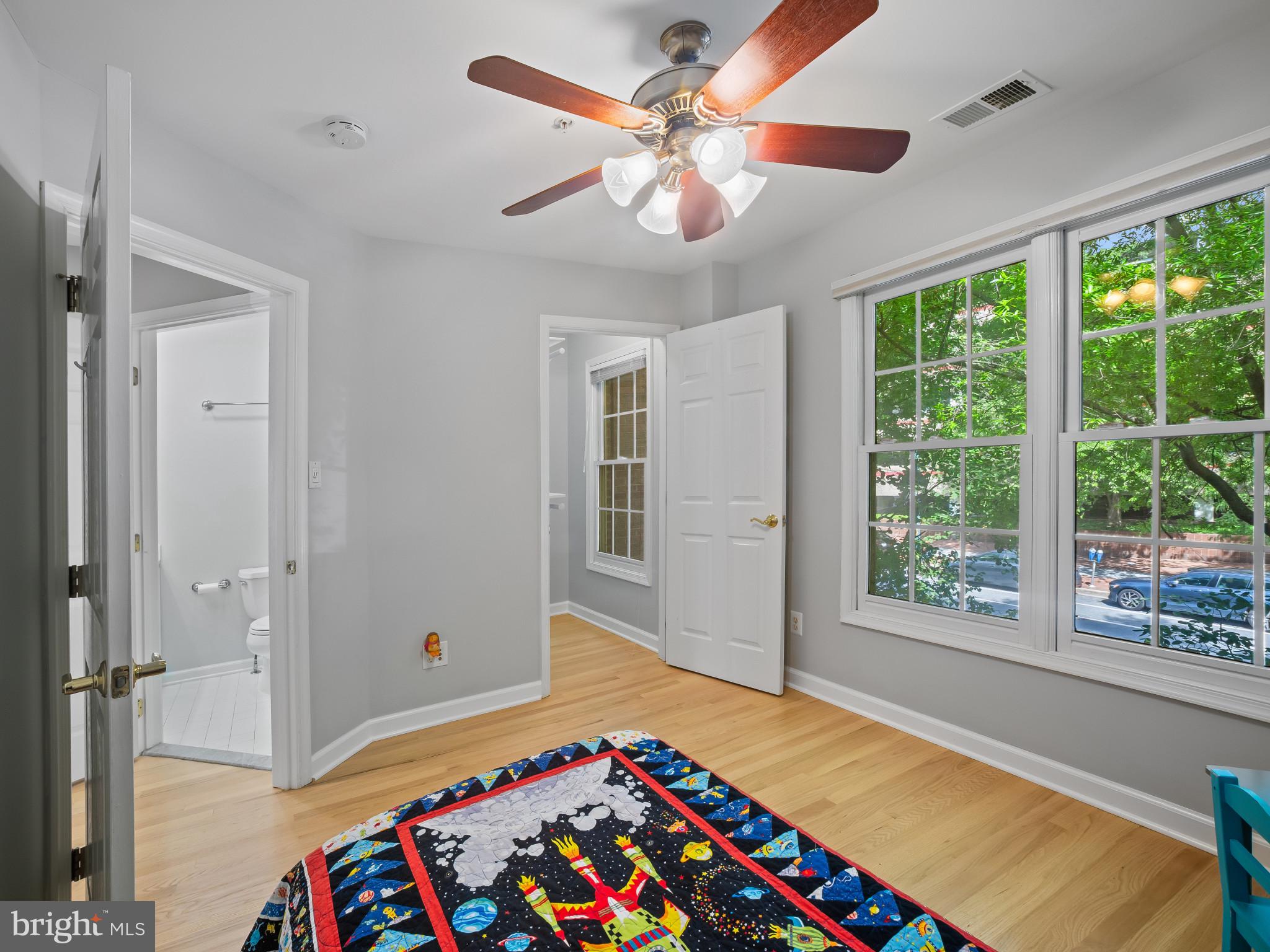 8511 Cameron Street Silver Spring, MD 20910 - Photo 19 of 39 a bedroom with a bed and a chandelier