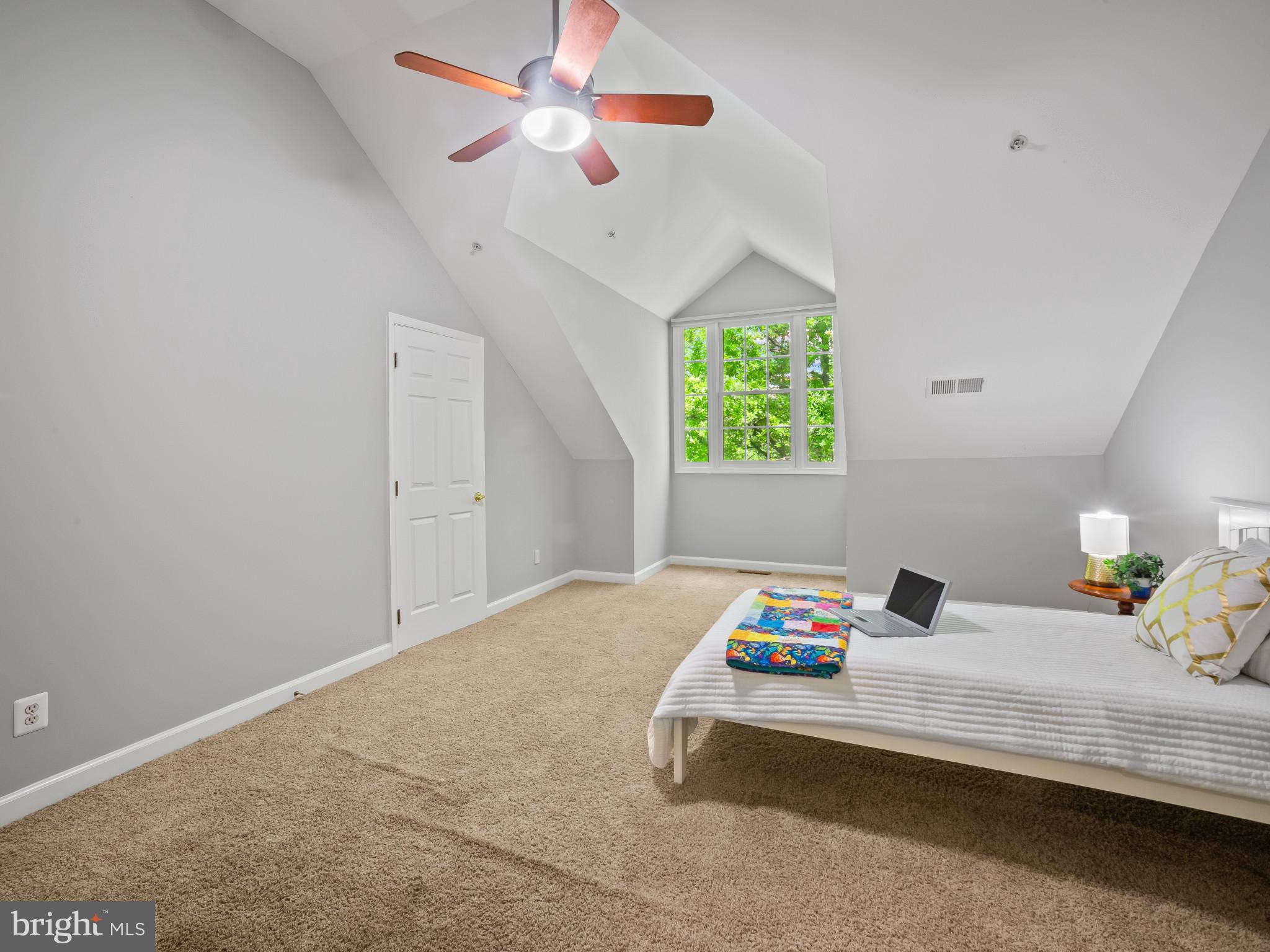 8511 Cameron Street Silver Spring, MD 20910 - Photo 21 of 39 a bedroom with a bed and a chandelier