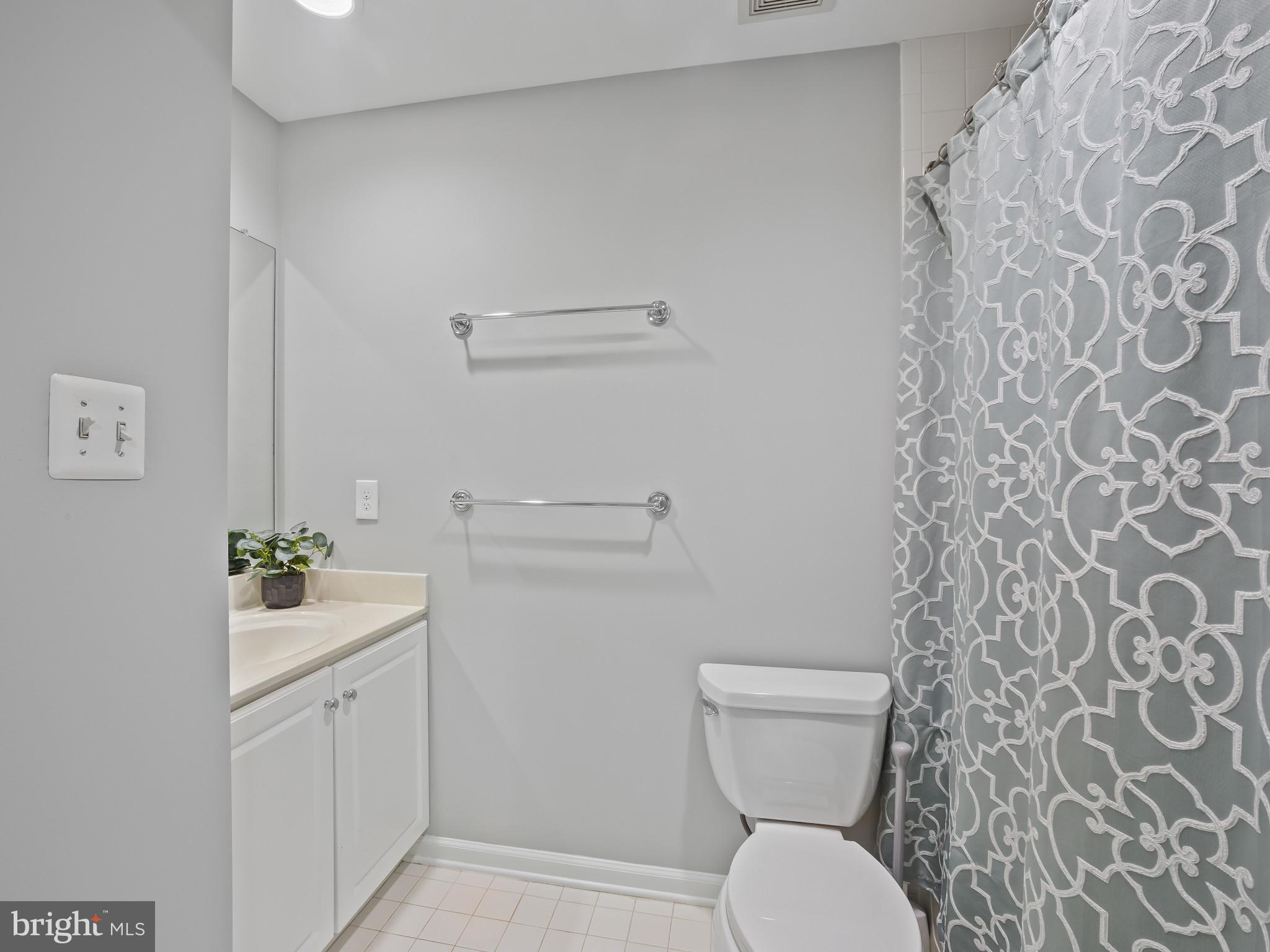 8511 Cameron Street Silver Spring, MD 20910 - Photo 24 of 39 a bathroom with a sink mirror and toilet