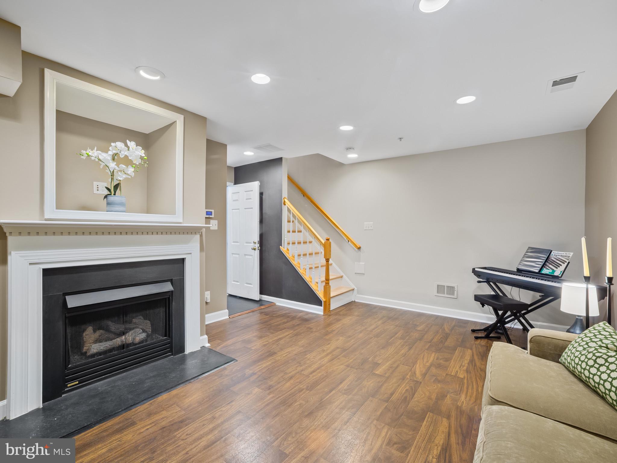 8511 Cameron Street Silver Spring, MD 20910 - Photo 25 of 39 a living room with furniture and a fireplace