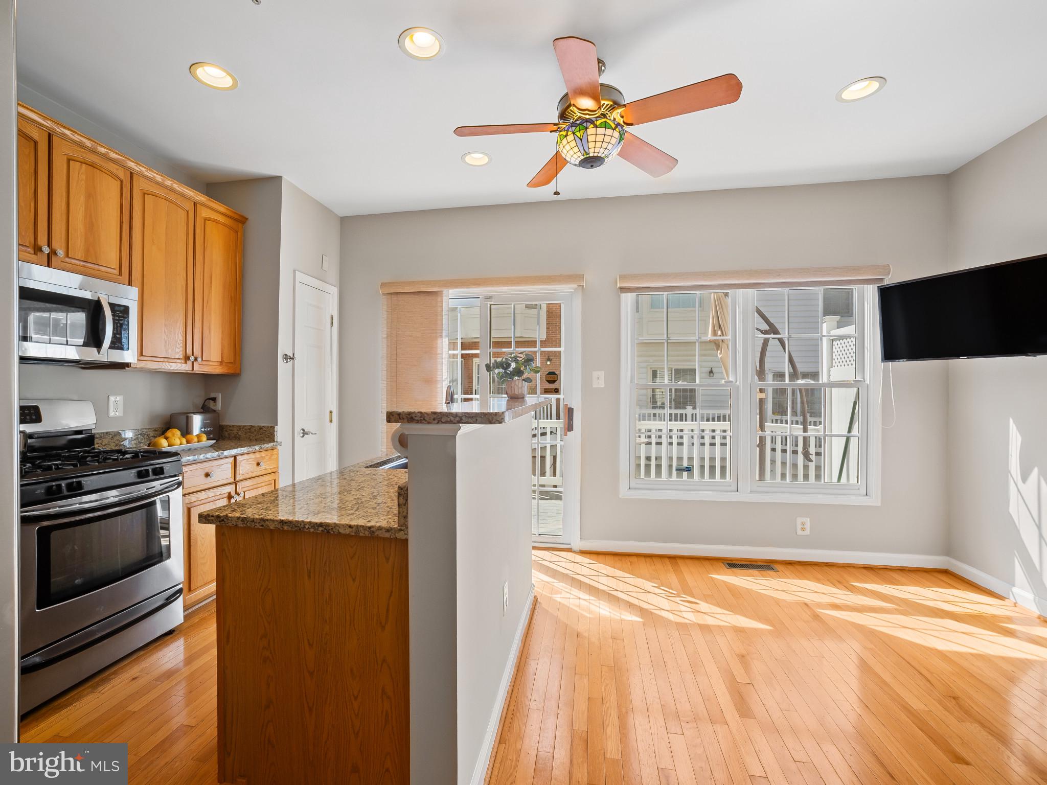 8511 Cameron Street Silver Spring, MD 20910 - Photo 5 of 39 a kitchen with stainless steel appliances granite countertop a refrigerator a stove top oven a sink and dishwasher