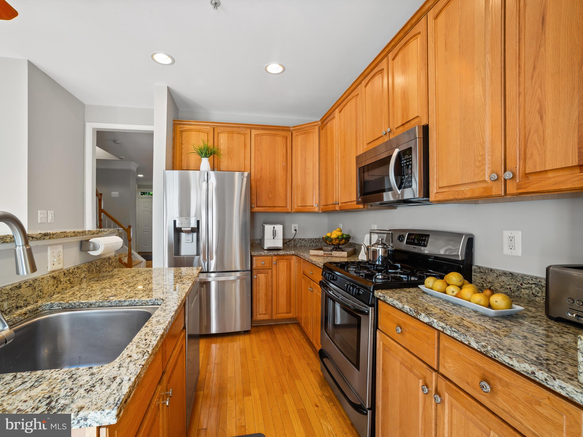 8511 Cameron Street Silver Spring, MD 20910 - Photo 7 of 39 a kitchen with stainless steel appliances granite countertop a sink stove and refrigerator