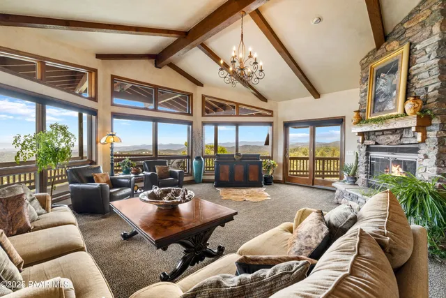 a bedroom with a bed chandelier and window