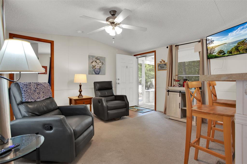 1793 Greer Road Sadler, TX 76264 - Photo 13 of 36 a living room with furniture a flat screen tv and a large window