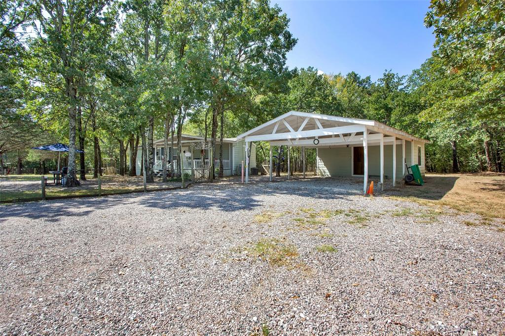 1793 Greer Road Sadler, TX 76264 - Photo 24 of 36 a view of a house with a yard and large trees