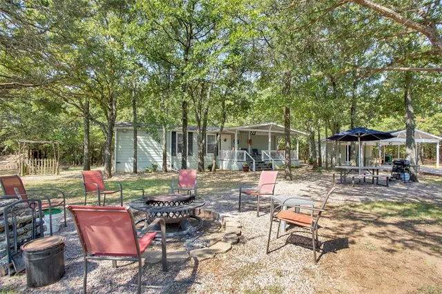 a view of backyard with outdoor seating and green space