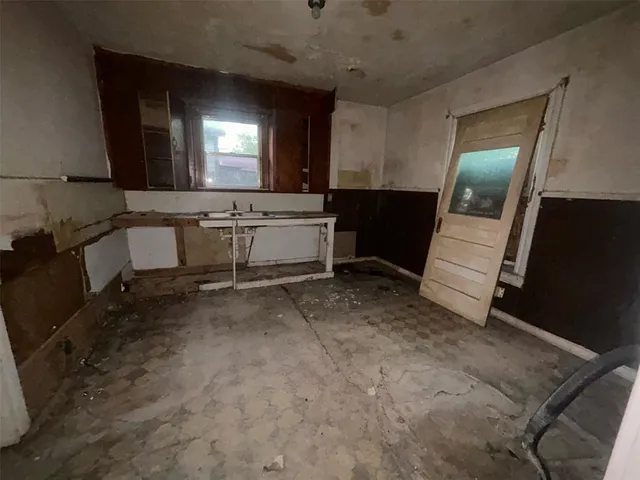 a bathroom with a sink and mirror with toilet