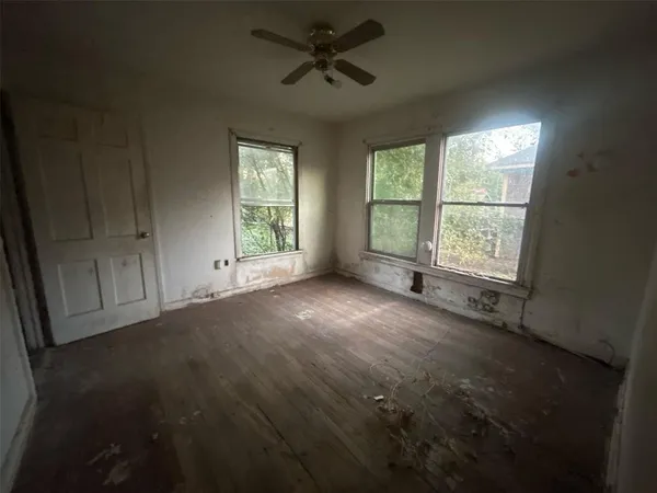 an empty room with windows and entrance