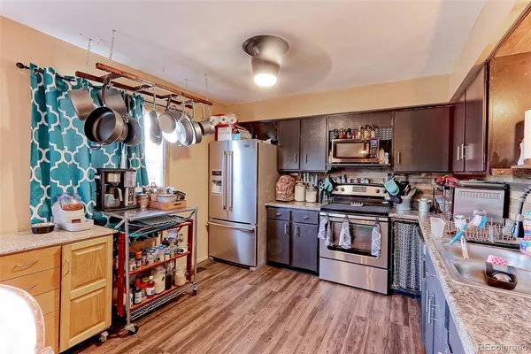 a kitchen with stainless steel appliances granite countertop a refrigerator and a stove top oven