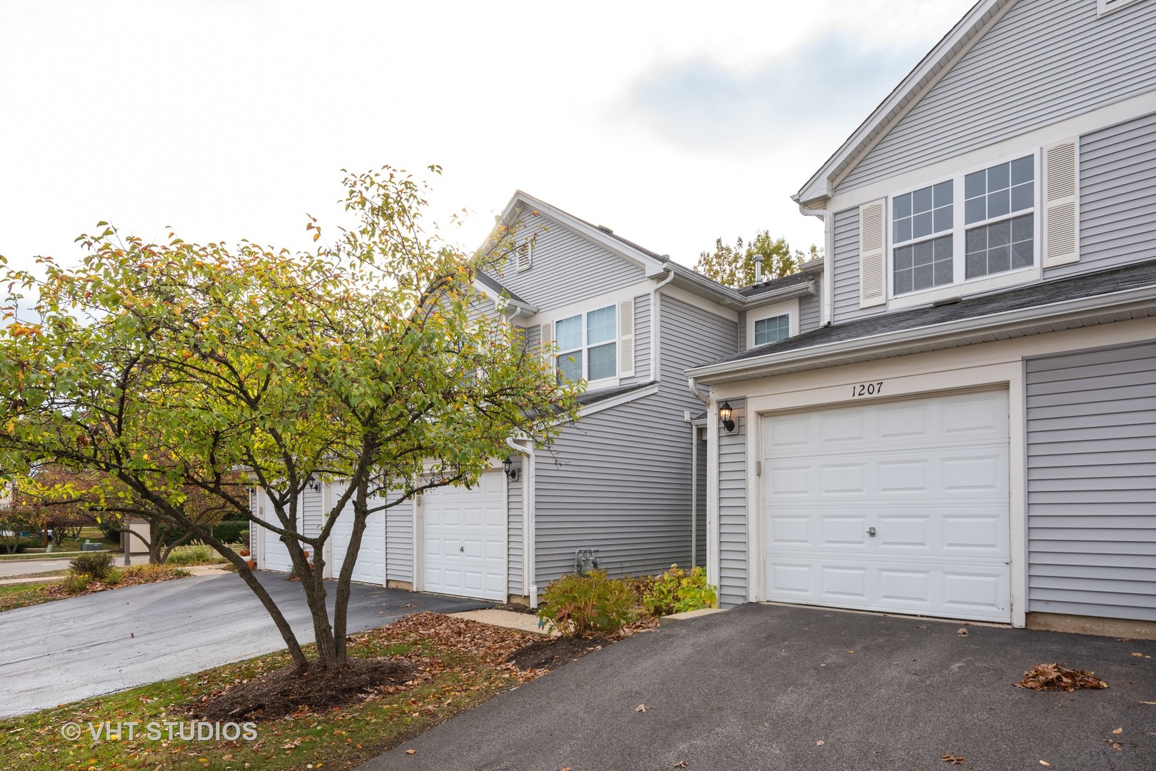 1207 Brookdale Drive Carpentersville, IL 60110 - Photo 1 of 14 a front view of a house with garden