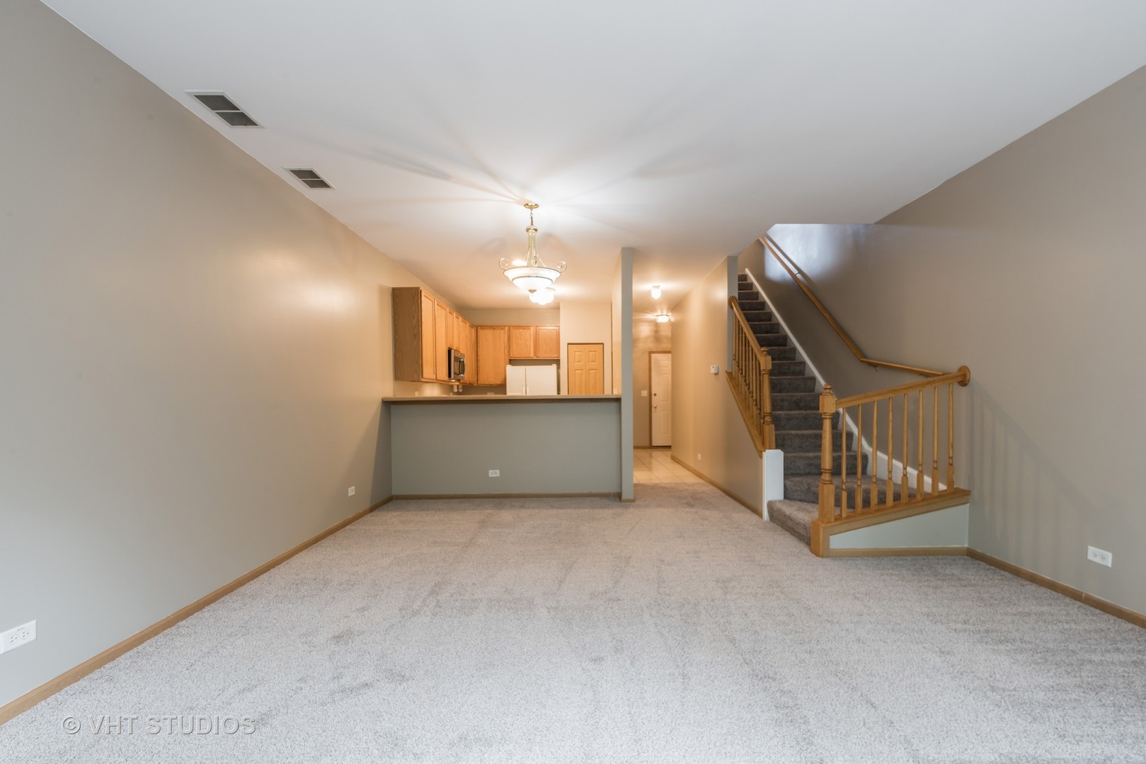 1207 Brookdale Drive Carpentersville, IL 60110 - Photo 6 of 14 a view of an empty room with wooden floor and windows