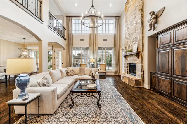 a living room with furniture a rug and a chandelier