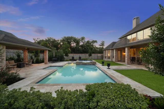 a view of a house with swimming pool and a yard