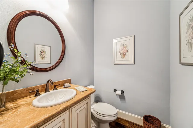 a bedroom with a bed a chandelier and a couch