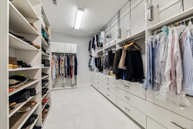 a bedroom with furniture and a large window