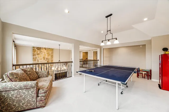 a living room with furniture and a book shelf