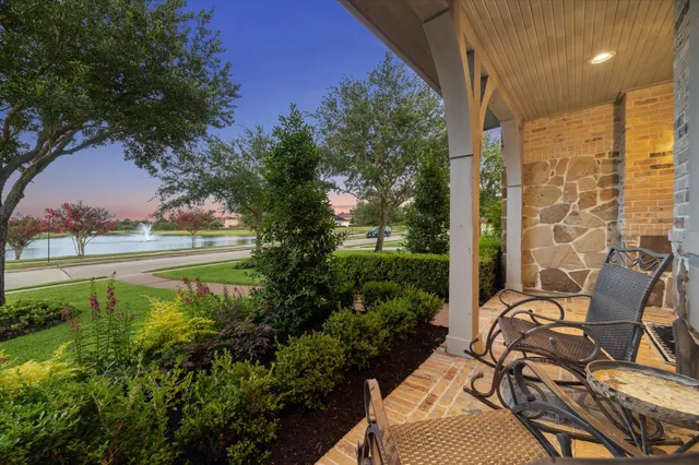 a view of swimming pool with outdoor seating and plants
