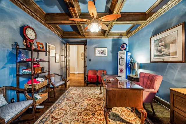 a view of a dining room and livingroom with furniture wooden floor a chandelier
