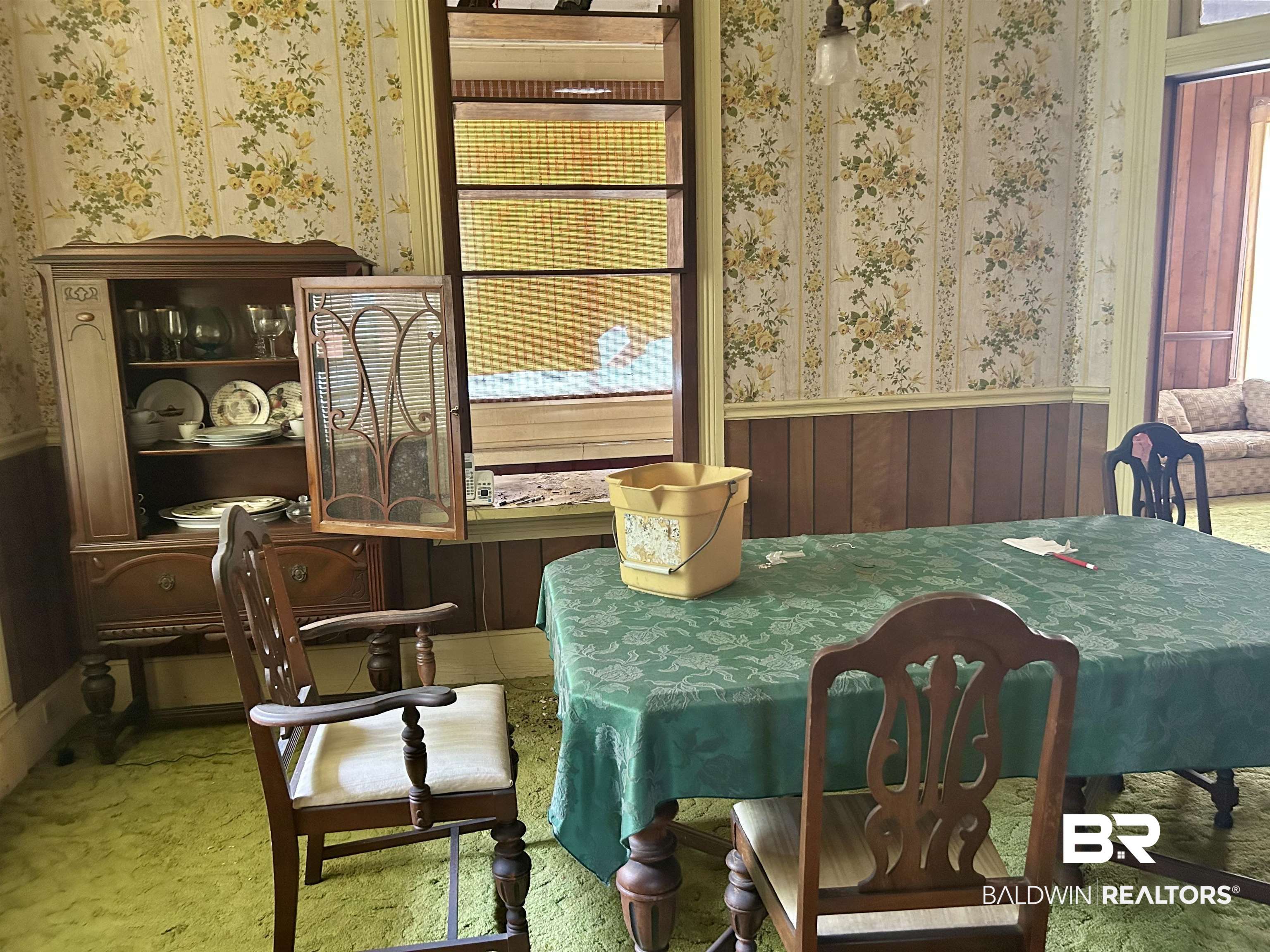302 Stocking Street Mobile, AL 36604 - Photo 18 of 31 Room featuring floral wallpaper, wood paneling, and a built-in china cabinet with leaded glass details