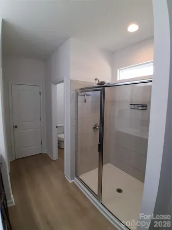 a bathroom with a glass shower door
