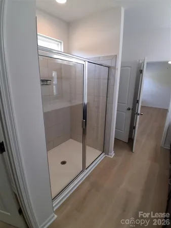 a bathroom with a glass door shower
