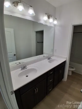 a bathroom with a double vanity sink and mirror