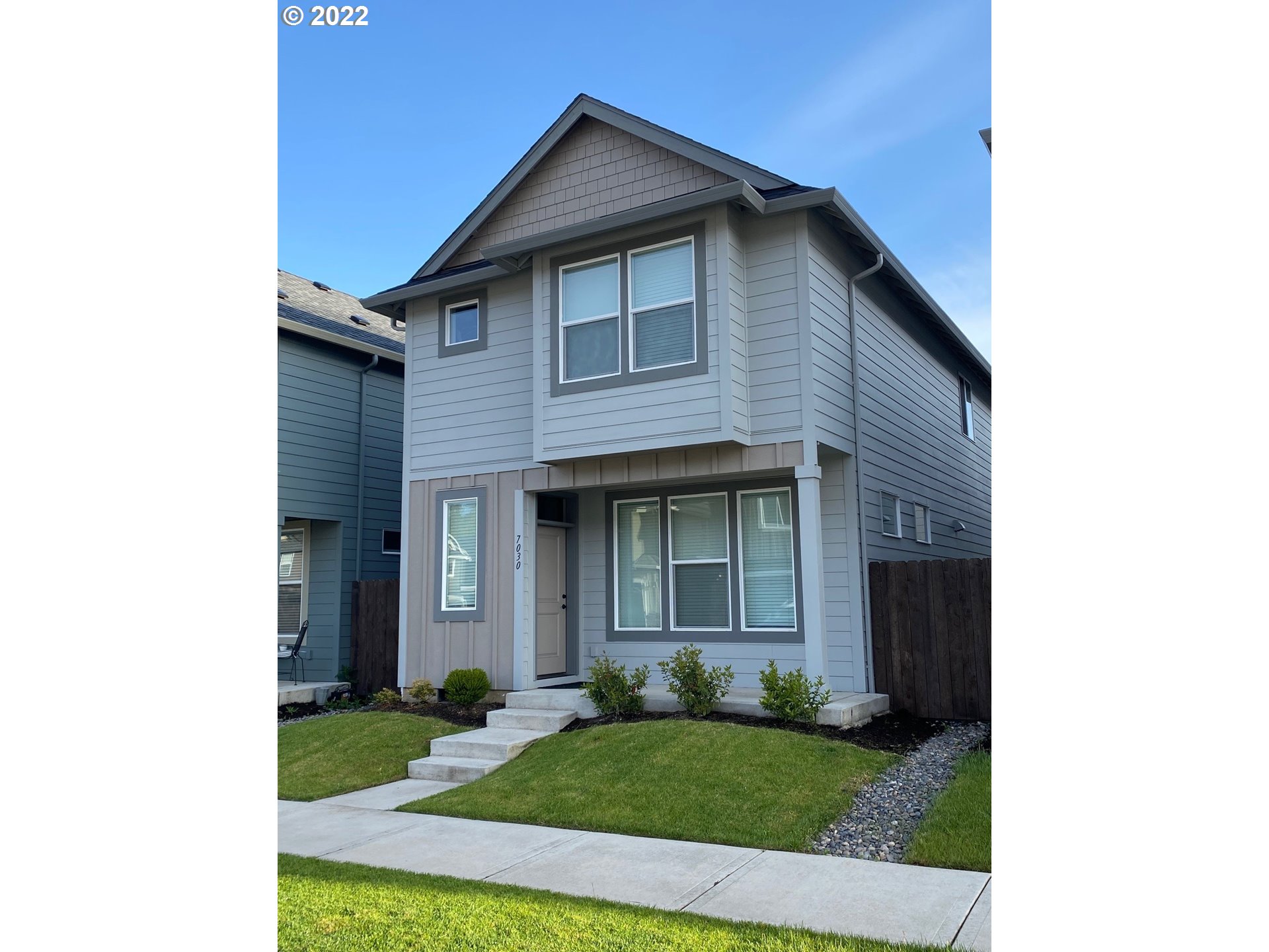 7030 South Ridge Way Ridgefield, WA 98642 - Photo 1 of 27 a brick house with a small yard