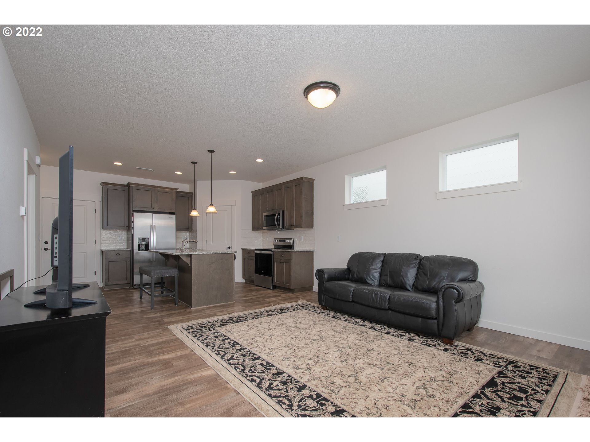7030 South Ridge Way Ridgefield, WA 98642 - Photo 4 of 27 a living room with furniture and a flat screen tv