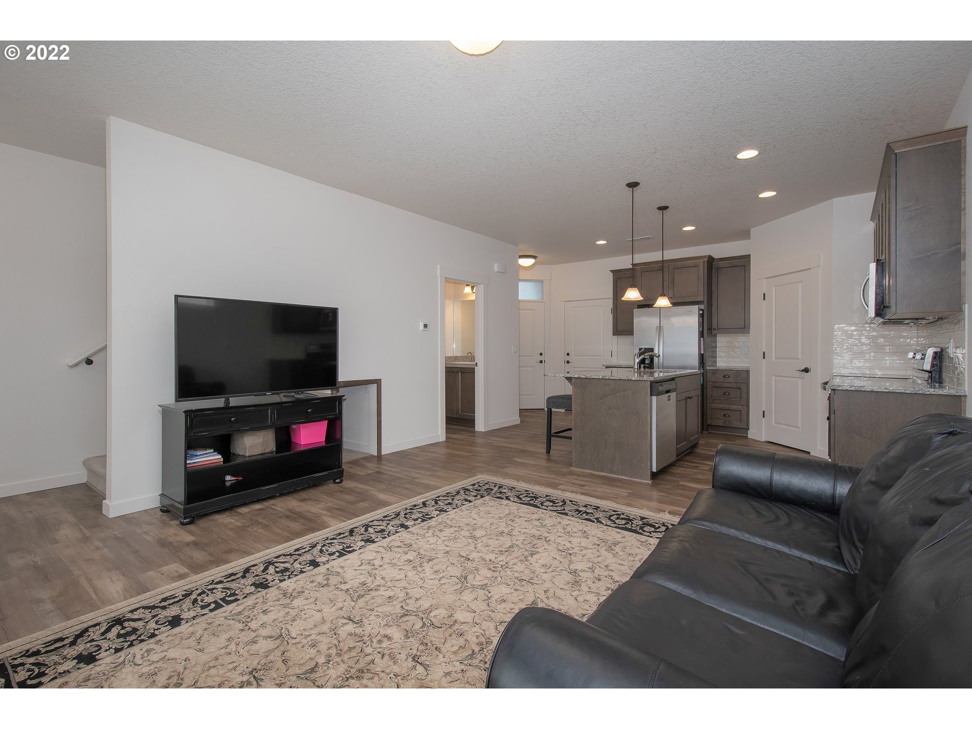 7030 South Ridge Way Ridgefield, WA 98642 - Photo 5 of 27 a living room with furniture and a flat screen tv
