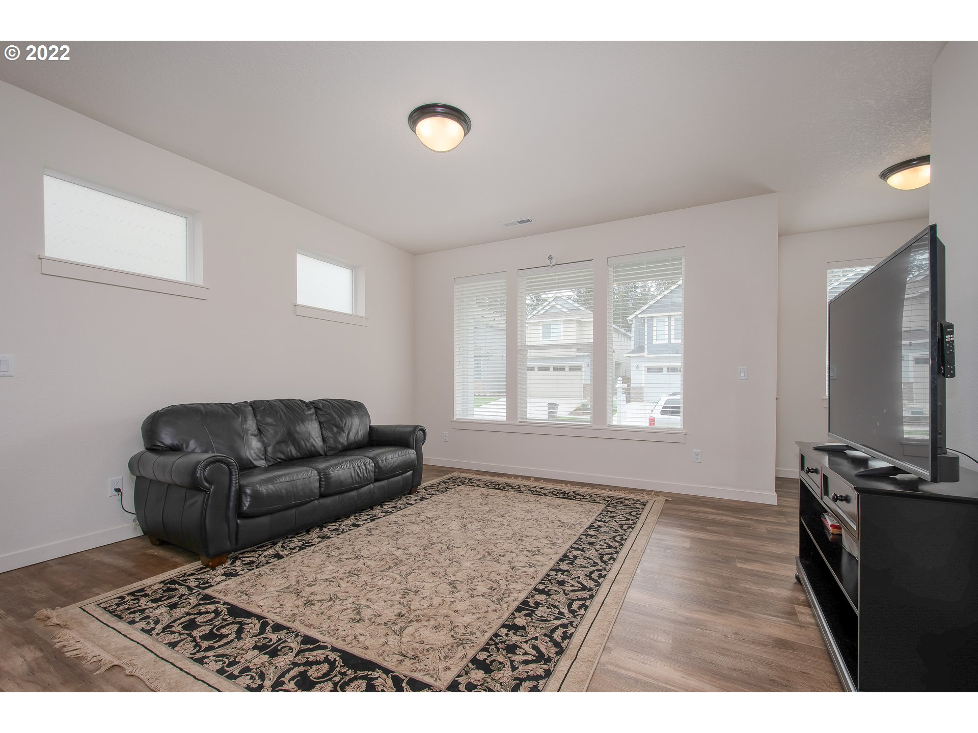 7030 South Ridge Way Ridgefield, WA 98642 - Photo 6 of 27 a living room with furniture and a flat screen tv